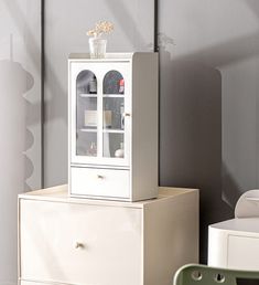 a white cabinet sitting on top of a dresser