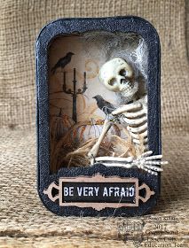 a miniature skeleton in a frame with the words be very afraid on it's side