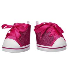 a pair of pink shoes with bows on the front and back side, all covered in glitter