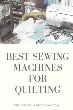 a sewing machine sitting on top of a bed next to a pile of quilts