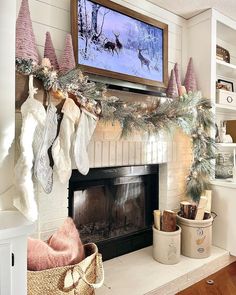 a fireplace decorated for christmas with stockings hanging from the mantel