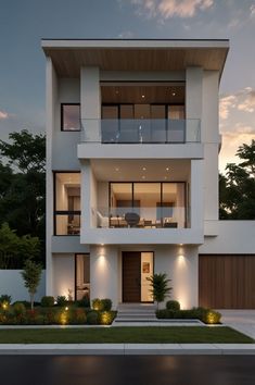 an image of a modern house at night with lights on the windows and balconies