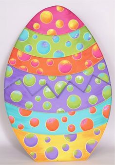 an easter egg painted with multicolored polka dots