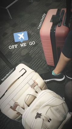 two pieces of luggage sitting on the floor next to each other with an off we go sticker