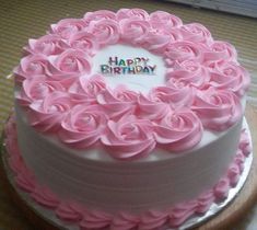 a birthday cake with pink frosting roses on it