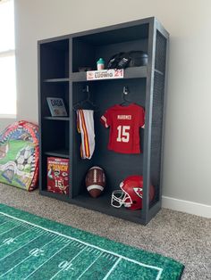 a football themed locker in the corner of a room with a rug on the floor