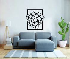 a living room with a couch, table and potted plant wall decal on the wall