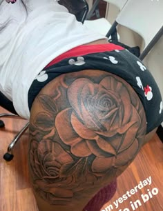 a woman with a rose tattoo on her thigh