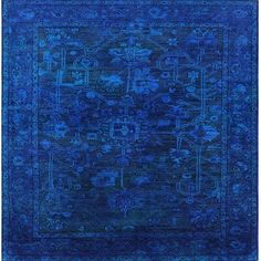 a blue rug with an intricate design on the middle and bottom, it is very ornate