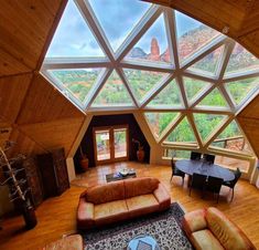 a living room filled with furniture and a skylight over the top of a building