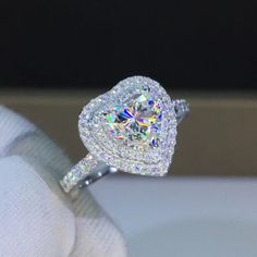 a close up view of a diamond ring on someone's finger