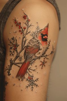 a red bird sitting on top of a tree branch with snowflakes around it