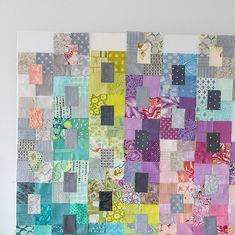 a large piece of art made out of different colored blocks and squares on a wall