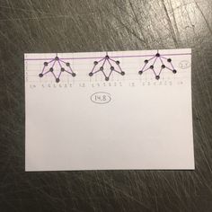 a piece of paper with lines drawn on it and dots in the shape of flowers