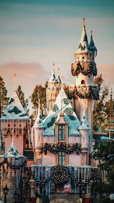 the disneyland castle is decorated for christmas