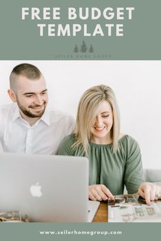 a man and woman sitting at a table with an apple laptop in front of them