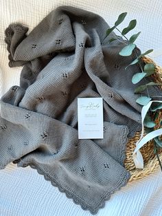 an image of a blanket and flowers on the bed