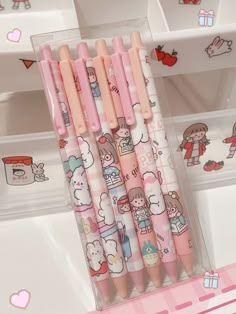 four hello kitty pencils sitting in a plastic container on a table with other stationery items