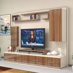 a flat screen tv sitting on top of a wooden entertainment center