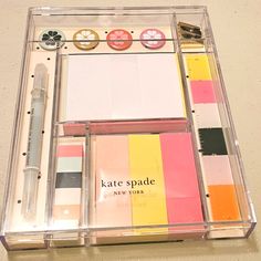 the contents of a stationery set in a clear box