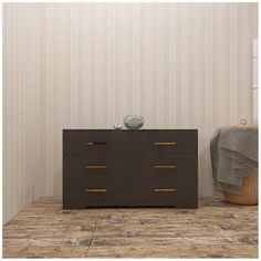 a brown dresser sitting on top of a wooden floor next to a basket and blanket