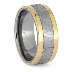 two tone gold and silver wedding band with an etched pattern in the center, set against a white background