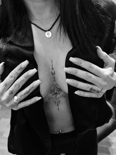 a woman with tattoos on her chest and hands