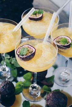 three glasses filled with drinks sitting on top of a table next to chocolate covered desserts