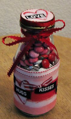 a jar filled with candy sitting on top of a wooden table