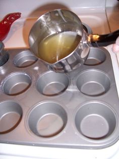 a person pours liquid into a muffin tin