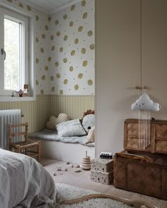 a bedroom with a bed, dresser and other items on the floor in front of a window