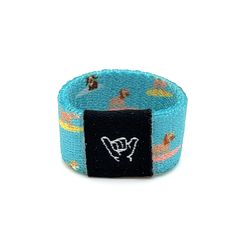 a blue wristband with surfers on it