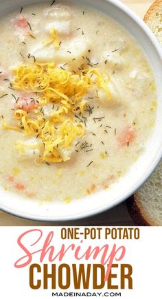 a white bowl filled with soup and topped with shredded cheese next to a slice of bread