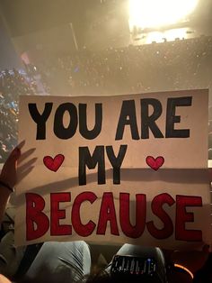 a person holding up a sign that says you are my because it's in the stands