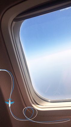 an airplane window looking out at the sky