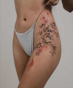 a woman's stomach with flowers and leaves on the side, showing her lower body