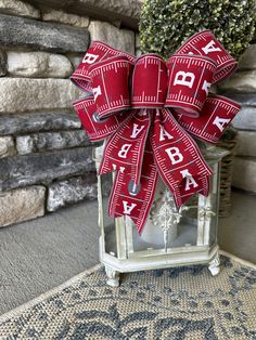 Handmade wreath bow perfect for an Alabama fan! Show your Roll Tide spirit by using the attached floral wire to update a wreath, lantern, or other home decor item. Ribbon is 2 1/2" wired and bow is approximately 10 1/2" wide and long. Alabama Football Wreath, Lantern Bows, Alabama Wreaths, Alabama Gifts, Wreath Bows, Small Wreath, Football Decor, Alabama Fans, Football Wreath