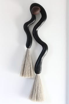 two black and white objects hanging on the wall