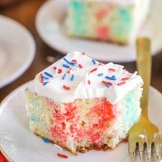 a piece of cake with white frosting and red, white, and blue sprinkles