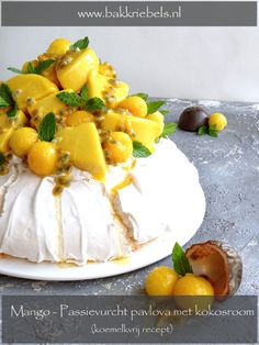 the cake is decorated with mangos, mint and other fruit toppings on it