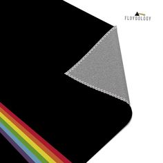 the fabric is black and grey with rainbows on it