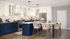 a kitchen with white cabinets and blue island