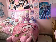 a bedroom with hello kitty bedding and pictures on the wall above it, along with stuffed animals