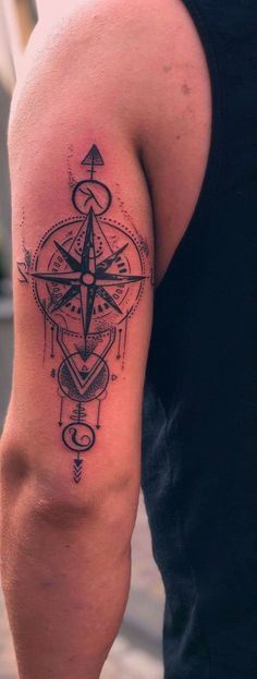 a man with a compass tattoo on his arm