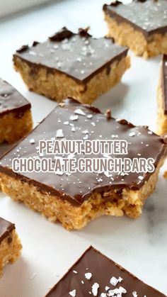 peanut butter chocolate and crunch bars on a white surface