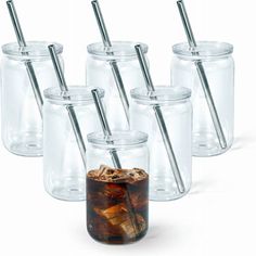 six clear glass mason jars with stainless steel straws and lids, each filled with ice