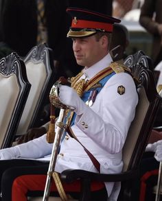 a man in uniform is sitting on a chair