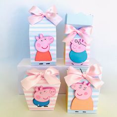 four peppa pig boxes with pink bows on them