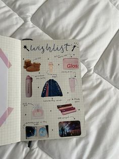 an open notebook with pictures and text on the cover, sitting on top of a bed