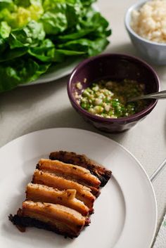 some food is sitting on a white plate and next to other foods that are in bowls